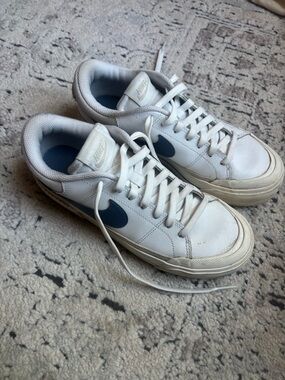 Nike women’s White Leather Sneakers with Navy Swoosh Accent